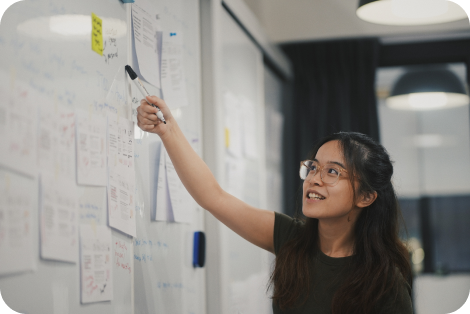 woman pointing at whiteboard